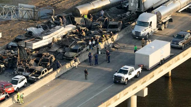 In this aerial photo, responders are seen near wreckage in the aftermath of a multi-vehicle pileup on I-55 in Manchac, La., Monday, Oct. 23, 2023. A “superfog” of smoke from south Louisiana marsh fires and dense morning fog caused multiple traffic crashes involving scores of cars