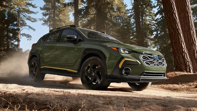 2024 Subaru Crosstrek driving on a dirt road.
