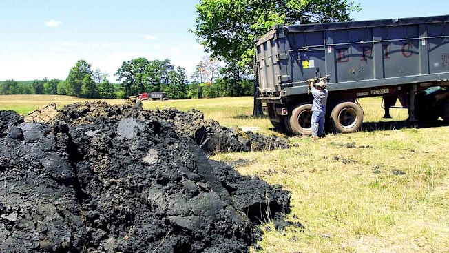A tractor trailer unloads human biosolids onto Tommy O'Brien's farm located off of Va. 654 in Appomattox, Va.