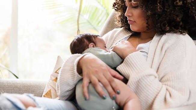 Woman breastfeeding newborn