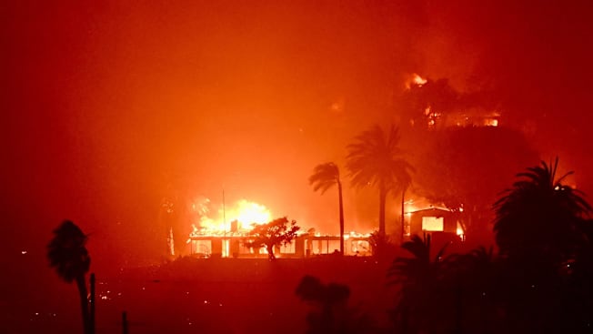 Homes burn above Pacific Coast Highway near Will Rodgers State Beach during the Palisades Fire on Wednesday, January 8, 2025, in Pacific Palisades, CA