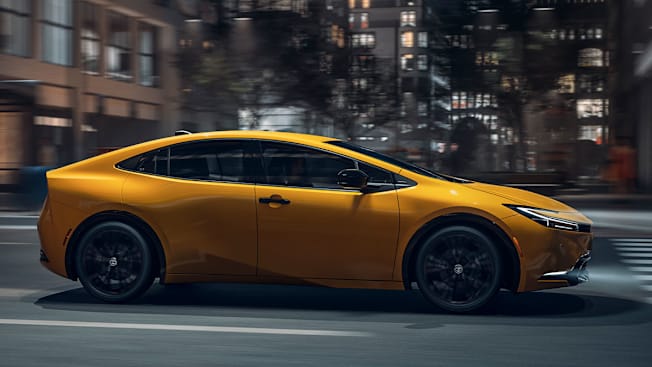 2025 Toyota Prius Nightshade driving through city at night