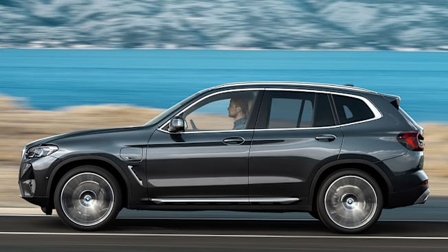 2022 BMW X3 driving by lake