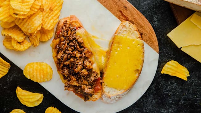 Oxtail Grilled Cheese and chips on a plate