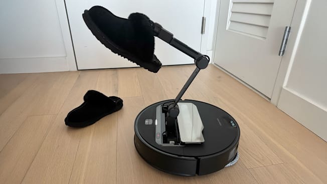 Roborock Saroz Z70 Robotic Vacuum holding a slipper