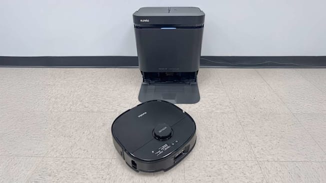 Eureka J15 Max Ultra base and vacuum on tan floor with grey wall