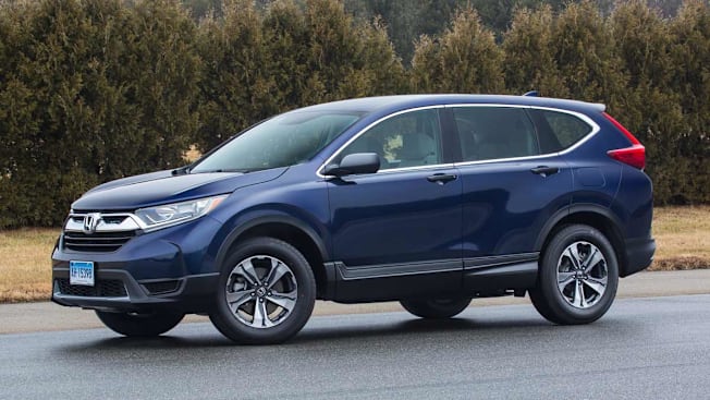 blue 2017 Honda CR-V on asphalt with trees and grass in background