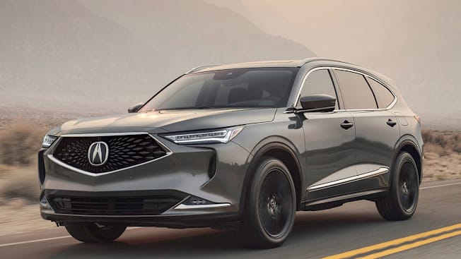 2023 Acura MDX driving on a scenic road