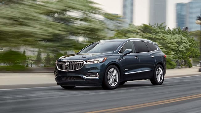 2021 Buick Enclave driving on an urban highway.