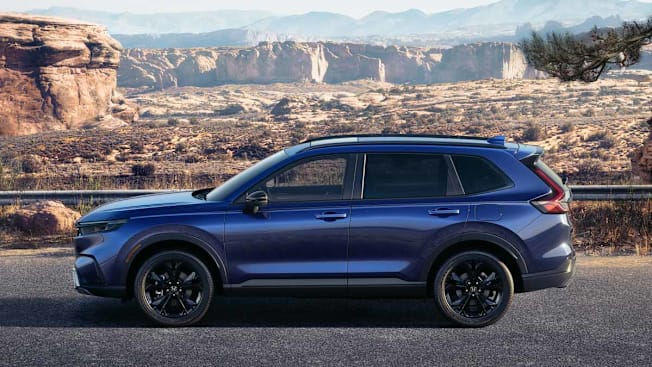 blue 2026 Honda CR-V Hybrid on road with desert landscape in background