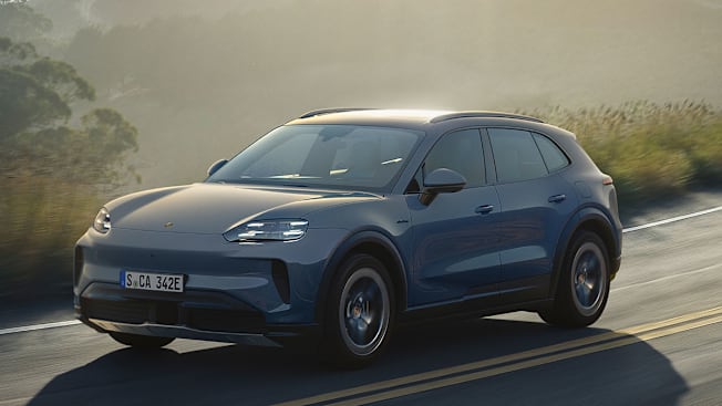 2026 Porsche Cayenne S Electric driving along a coastal road