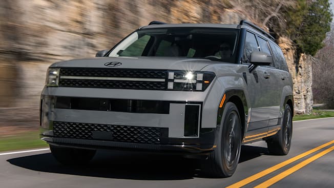 2024 Hyundai Santa Fe driving along a rock wall