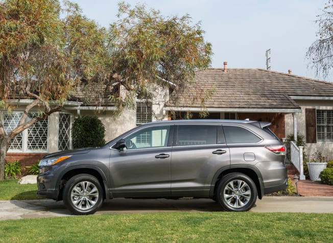 grey 2015 Toyota Highlander parked in front of a house
