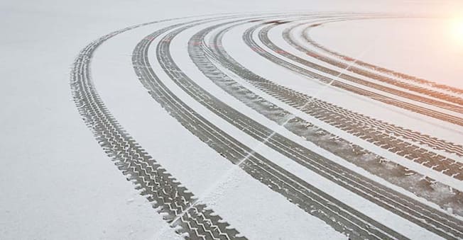 Car tire tracks in snow