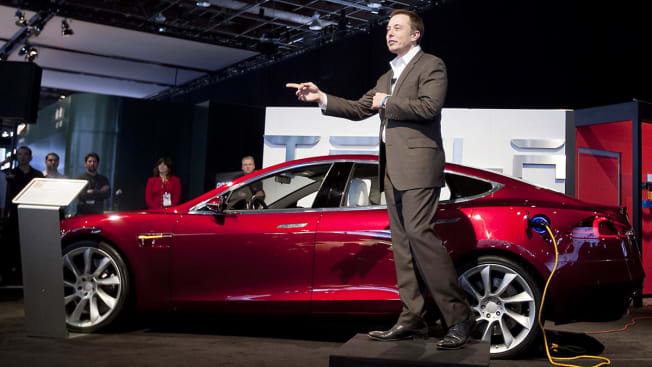 Elon Musk, chairman and chief executive officer of Tesla Motors Inc., speaks in front of a Tesla Model S electric car on day two of the 2010 North American International Auto Show in Detroit, Michigan, U.S., on Tuesday, Jan. 12, 2010. The 2010 Detroit auto show runs through January 24 and features 60 new vehicle premieres.