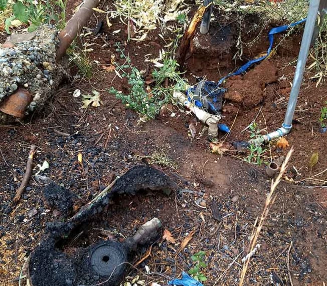 Wildfires, such as one in Paradise, Calif., that damaged this water meter, can release dangerous chemicals into water supplies.