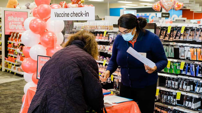A worker checks in a person with an appointment to receive a dose of the Moderna Covid-19 vaccine at a CVS Pharmacy location in Eastchester, New York,