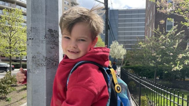 child with apple air tag on backpack