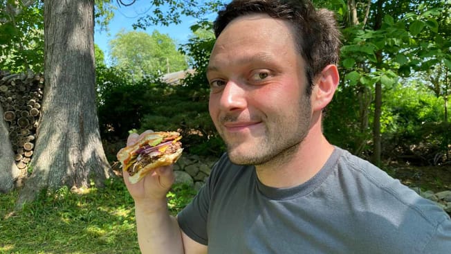 Paul Hope eating a plant-based burger.