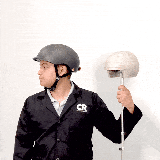 gif of technician wearing helmet and holding headform for helmet testing