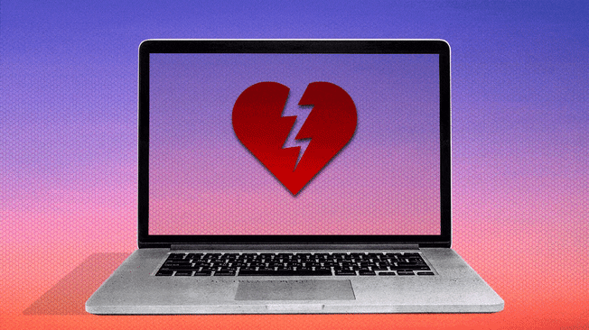 Laptop computer opened with a broken heart blinking on its screen.
