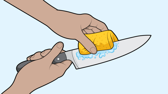 Cleaning a chef's knife with a sponge