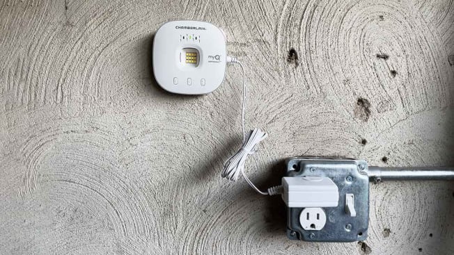 Key by Amazon charging unit plugged into an electrical outlet