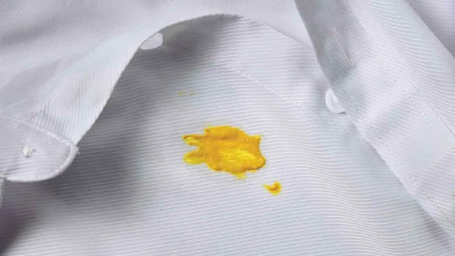 mustard stain on white collared shirt