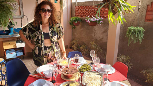Renata Castro at a table with food