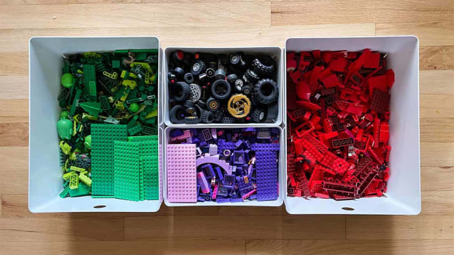 Legos organized by color in bins