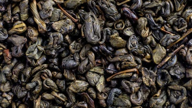 detail of dried green Chinese oolong tea leaves