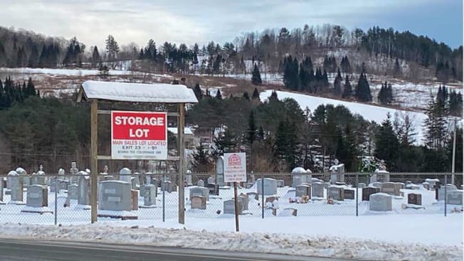 sign in front of cemetery advertising for a storage lot