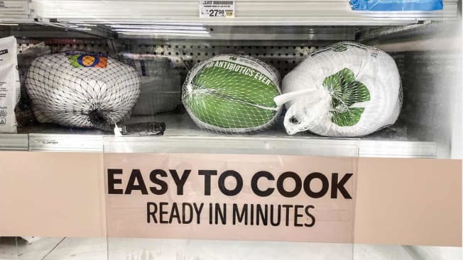 frozen turkeys in freezer with "easy to cook ready in minutes" sign under them