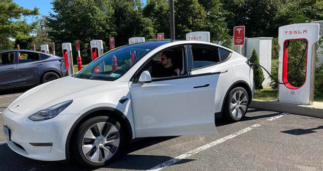 Teslam Model Y at a Supercharger