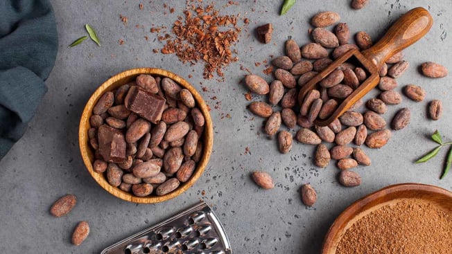 cocoa beans and powder on grey background