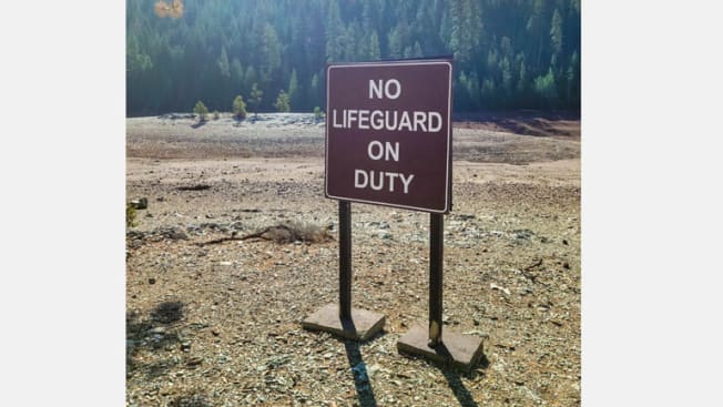 No Lifeguard on Duty sign in the middle of dry area