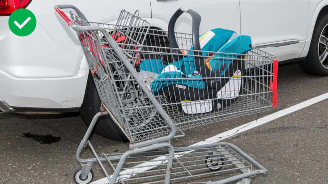 Infant car seat in a shopping cart basket.