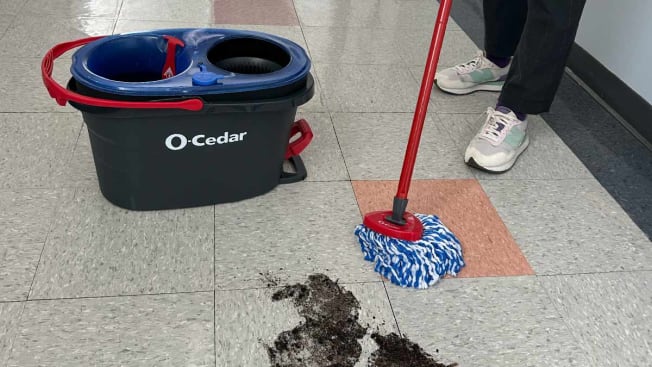CR tech testing on an O-Cedar mop in a hallway at CR headquarters.