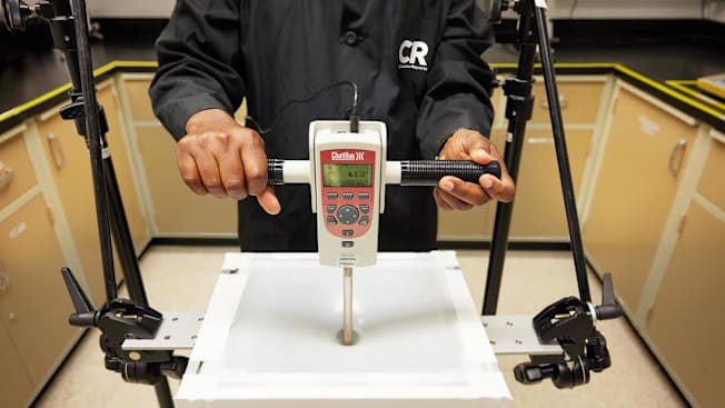 A test where a section of the trash bag is clamped and pierced with a blunt rod to measure the force needed to break it. Higher force indicates a stronger bag.