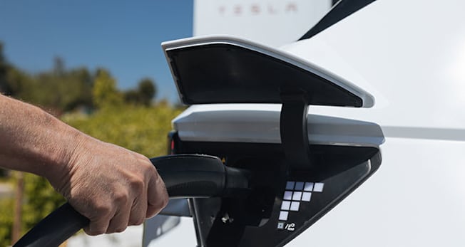 Hyundai Ioniq 5 plugged into a Tesla charger