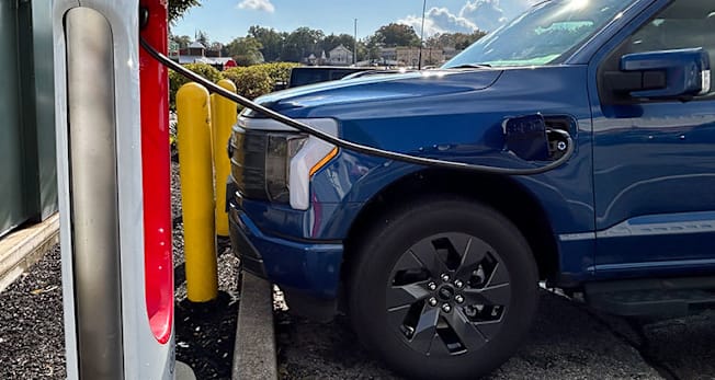 Ford Lightning charging at a Tesla Supercharger with an NACS adaptor