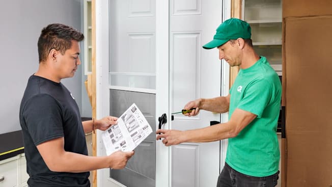 Consumer Reports testers installing a storm door