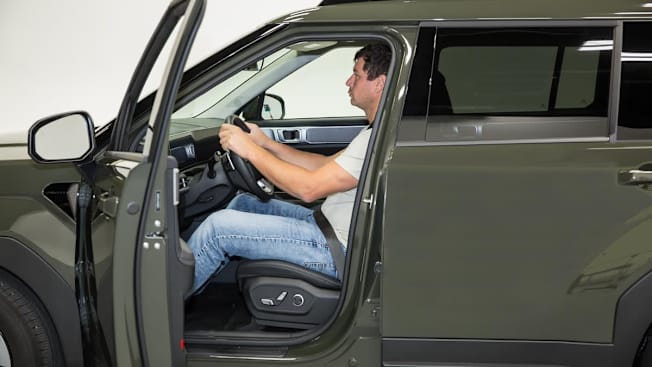 a person sitting inside a large SUV