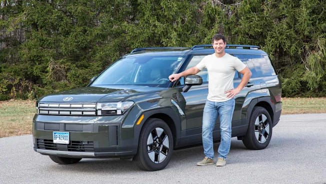 a person standing outside a large SUV