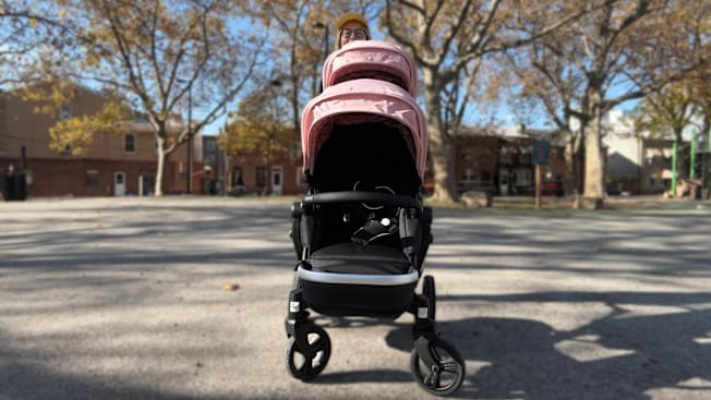 Angela Lashbrook standing behind the Mockingbird 2.0 Stroller