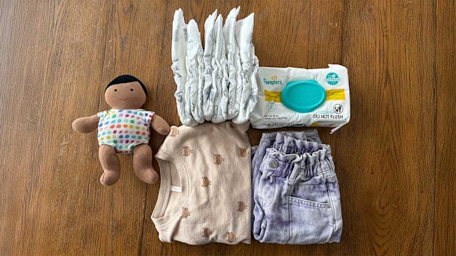 doll, diapers, baby clothes, baby wipes