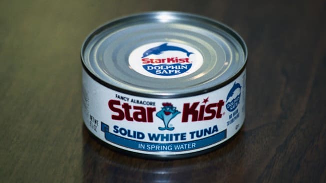 A can of Star Kist solid white tuna from 1990 with a sticker on it claiming to be "Dolphin Safe"