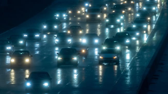 Numerous cars seen on a highway at night.
