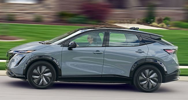 2025 Nissan Ariya driving through neighborhood.