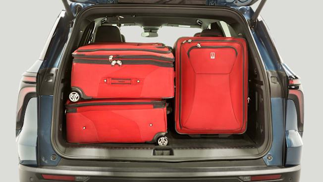 back of Chevrolet Traverse with lid open, showing 3 red suitcases